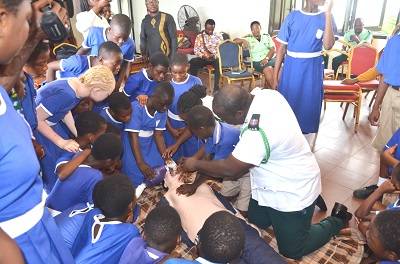 Officers of the National Ambulance Service showing the school children how to resuscitate an accident victim. Photo. Vincent Dzatse