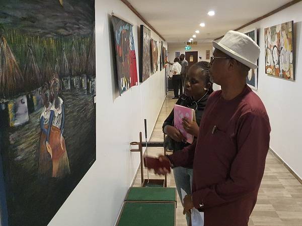 Mr.Lamptey explaining a point to the reporter on the painting. Photo Godwin Ofosu-Acheampongjpg