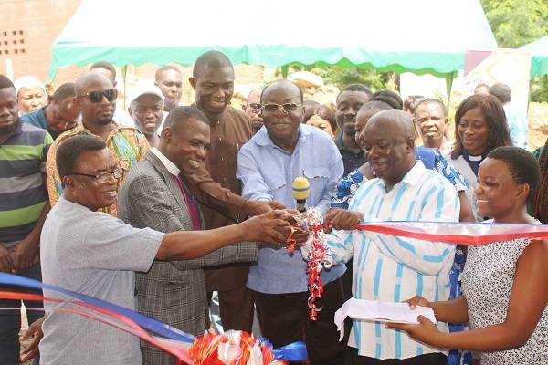 Inset ; Mr Freddie Blay (middle) being assisted by other dignitaries to cut the tape to inaugurate the Krobo Girls Presbyterian SHS Home Economics block facility. Photo. Ebo Gorman