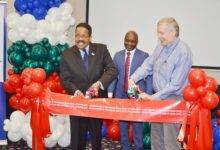 Mr Michael Andersson(left)of USAID,Mr Matthew Anderson(right)also of USAID cutting the tape to inaugurate the office, with them is Mr Golden Mahove. Photo. Vincent Dzatse