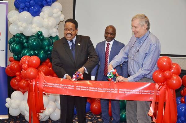 Mr Michael Andersson (left), Mr Matthew Anderson (right) cutting the tape to inaugurate the office. With them is Mr Golden Mahove Photo Vincent Dzatse