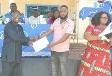 Mr Obeng (left) presenting a certificate to a graduands. Photo Victor A. Buxton
