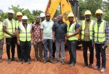 The Member of Parliament (fourth from right) and contractors after cutting the sod