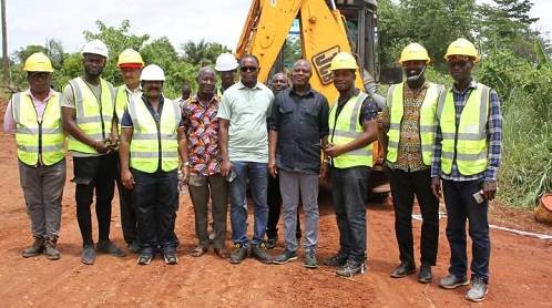 The Member of Parliament (fourth from right) and contractors after cutting the sod