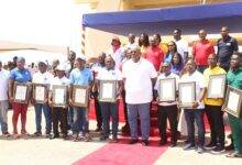 Mr Henry Quartey (middle) with some awardees workers at the Blackstar Square in Accra. Photo. Ebo Gorman