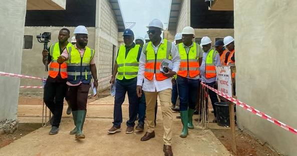 Mr Kojo Oppong Nkrumah (second from right), Dr Nsiah Asare (second from left) and others touring the Agenda 111 ongoing project .