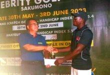 • Manasseh (right) receiving his prize from Mr Tang Hang