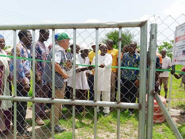 Alhaji Sulemana (right) assisting the community chief to cut the tape to inaugurate the solar-powered irrigation system