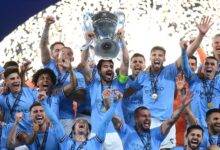 Manchester City players celebrate with the Champions League trophy