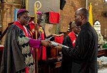 Most Rev. Boafo presenting a bible to one of the new Ministers