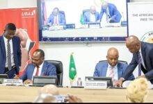 Mr Akinyemi (left) and Mr Mene signing the agreement