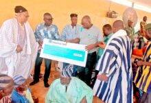 Mr Gyebi(second from left) handing over the cheque to the elders of the palace