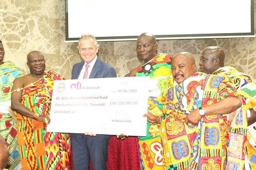 Mr Manley Gerard (fourth from right) presenting the dummy cheque to Katakyie Kwesi Bumagama II, (left),Paramount Chief of Sefwi Wiawso, Traditional Area. Photo. Ebo Gorman