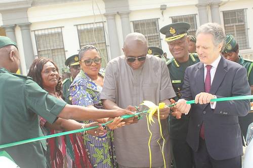 • Inset: Mr Ambrose Dery (middle) being assisted by Mr Javier Guitierrez (right), Mr Kwame Takyi Asuah (second from right) and other guests to cut the tape to inaugurate the vehicles . Photo: Ebo Gorman