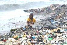 A child openly defaecating at a seashore in Tema Newtown, Accra