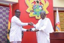 Mr Alban Bagbin (right) presenting the Constitution and the Standing Orders of the Parliament to Mr James Gyakye Quayson