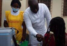 A woman receiving a COVID-19 jab from the MP, Dr Adomako Kissi at the launch