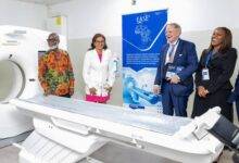 Mr Grant (left) and Dr Wulff (second from left) inspecting the CT scanner with . With them are Dr Oyeyinka (right) and Mr VanSchaik.