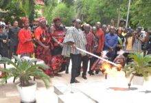 Dr Awal lighting the perpetual flame at the George Padmore Library. With him are other dignitaries Photo Victor A. Buxton
