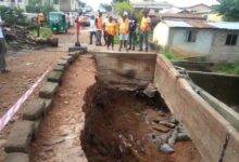 • Ms Ivy Amewugah (left) with Mr Richard Bosson (right) and others inspecting a damaged bridge at Aleke