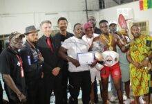 • MMA champion, Jonathan Lamptey, (second right with trophy) with dignitaries and organisers after the event