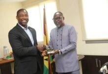 Mr Osei Asibey (right) presenting a miniature trophy to Dr Okoe Boye