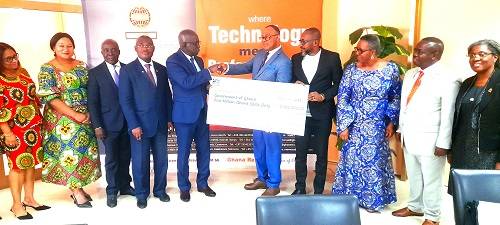 • Mr Otoo (fifth from left) presenting a dummy cheque to Mr Okyere-Mensuo