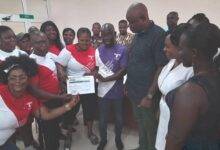 Mr Affum(middle) presenting the receipts for the cement bags to Mr Eric Fosu(third from right)