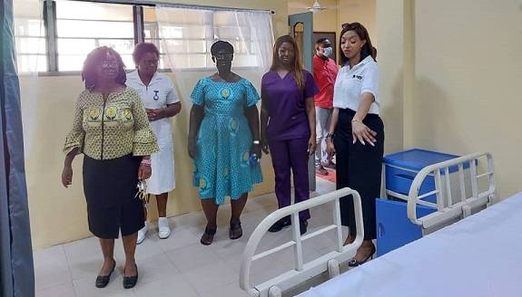 Inset; Dr Stella Gyamfi (in front ), together with some members from OA touring the facility