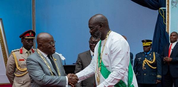 • President Akufo-Addo (left) exchanging greetings with Liberia President George Manneh Oppong Weah