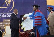 • President Akufo-Addo (left) receiving a citation from Prof. William Koomson