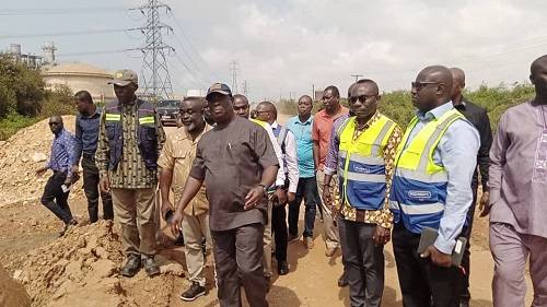 Mr Amoako Atta (third from right) and other officials inspecting the road
