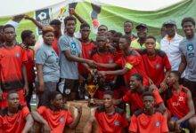 • Jed Akwaboah presenting a trophy and equipment to Miracle Land FC