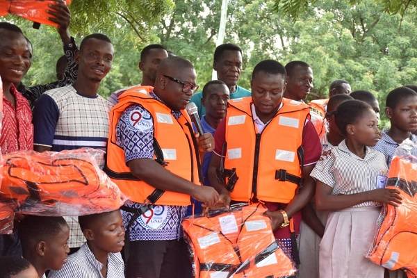 Rev Isaac Owusu, President, GNAT, handing over life jackets to teachers in Oti Region