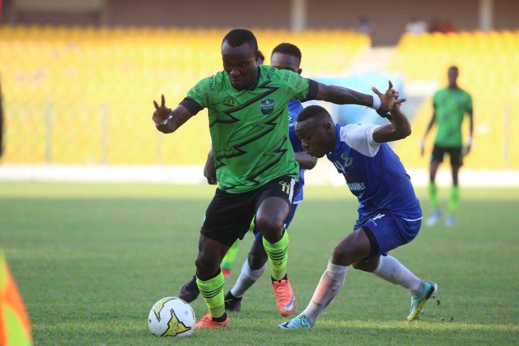 A midfield action in the Dreams FC versus Milo FC game