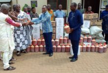 Mr Adumuah (Second from right) presenting the items to the chiefs