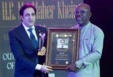Mr Kheir (left) receiving his award from Mr Gaisie-