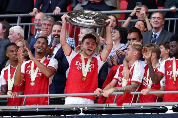 Arsenal players celebrate with the Community Shield which they won after defeating Manchester City