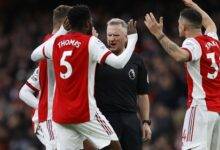 Arsenal players confronting a referee