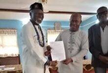 Asafoatse Bebe-FoliKangni Mathias (left) receiving his certificate of authority from a government official
