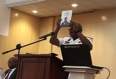 Rear Admiral Issah Yakubu displaying the book during the launch.