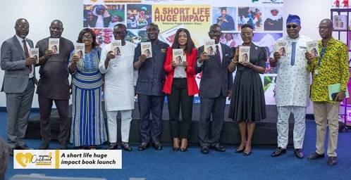 Mr Addai (fifth from left) with other participants displaying the book