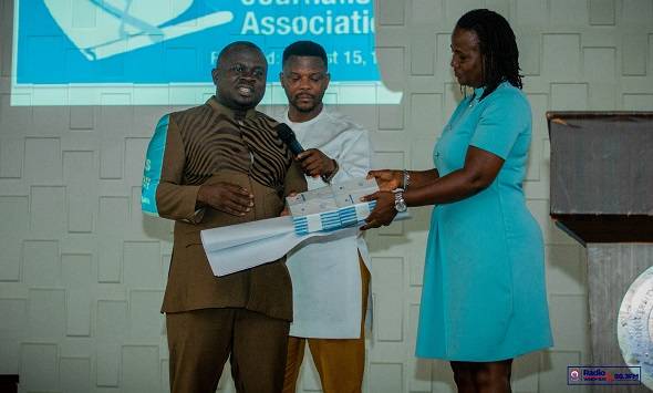• Mr Dwumfour handing over copies of the GJA Code of Ethics to Dr Gifty Appiah-Adjei after the seminar