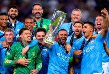 Man City players celebrating with the trophy