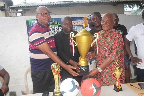 • Mr. Addai-Danquah presents the trophy and other prizes to the organising committee