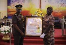 Corporal Edawrd Opoku (right) receiving a citation from Mr Isaac K. Egyir