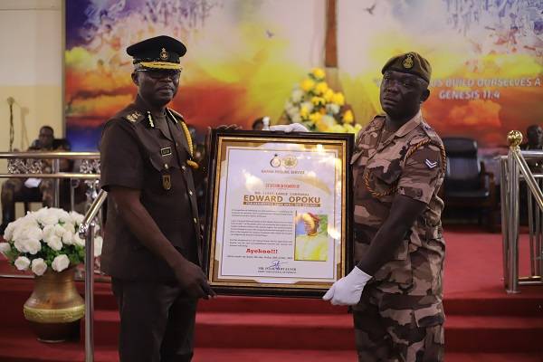 Corporal Edawrd Opoku (right) receiving a citation from Mr Isaac K. Egyir