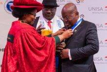 President Akufo-Addo (right) being decorated the award at the programme