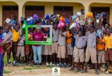 Hajia Salifu with the beneficiary students as they display their items