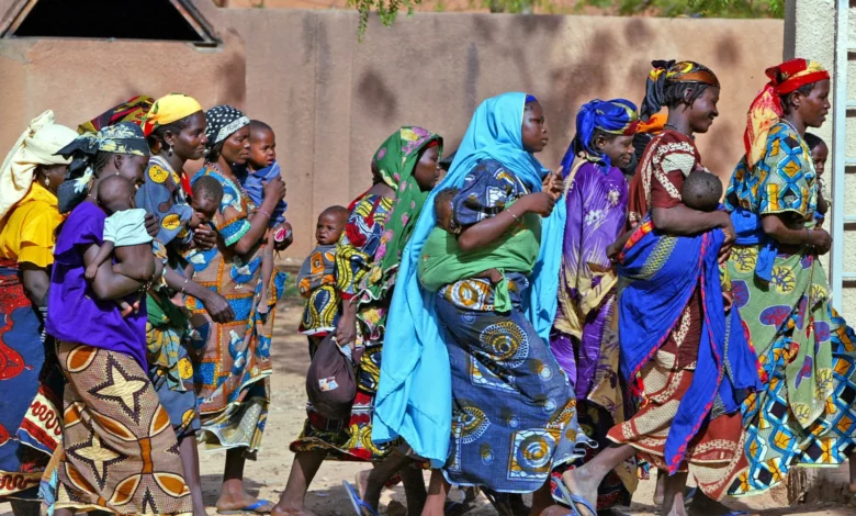 • Women and children rush towards an emergency feeding centre